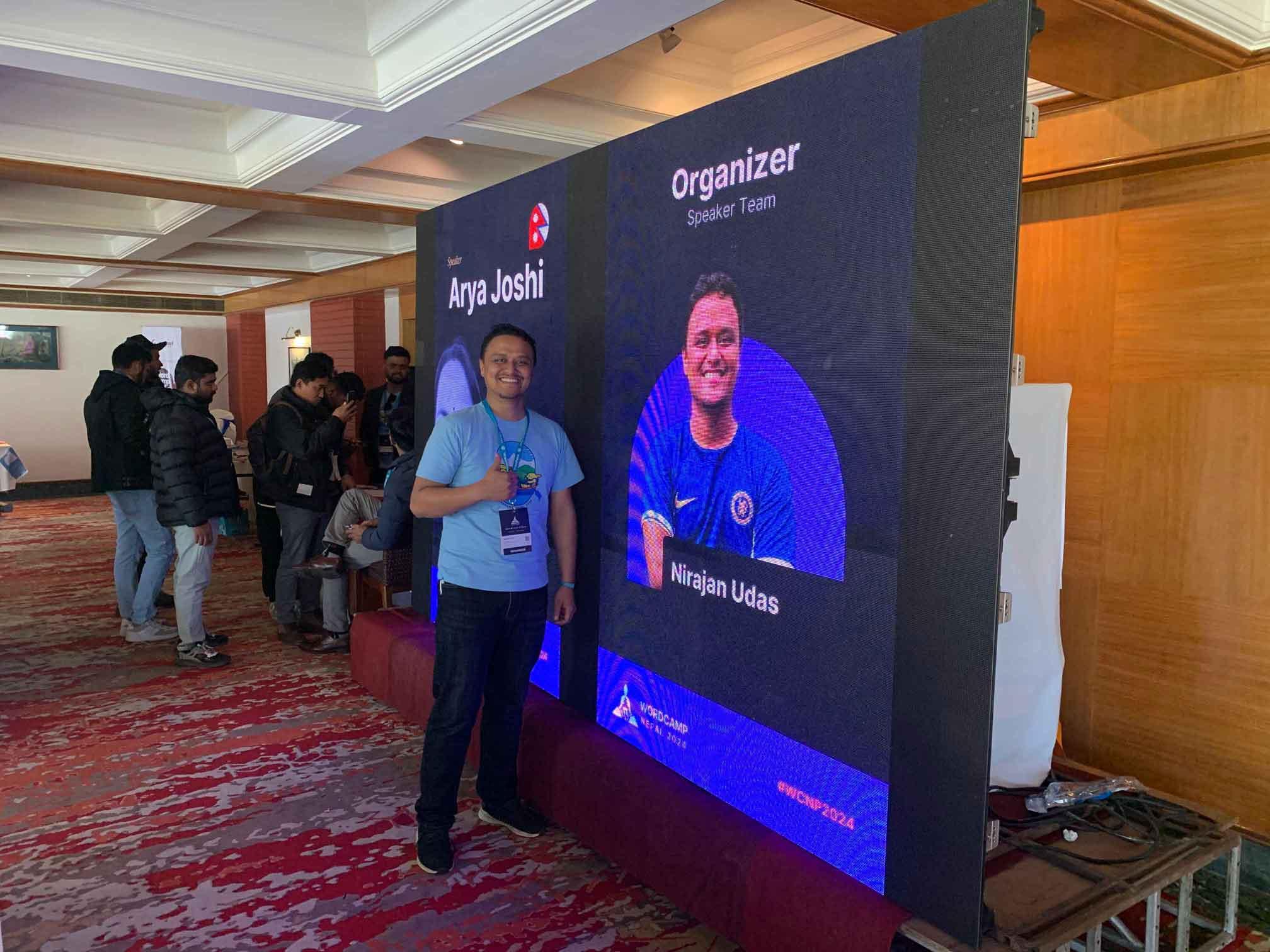 Me, posing in front of me, in Nepal's biggest WordCamp.
